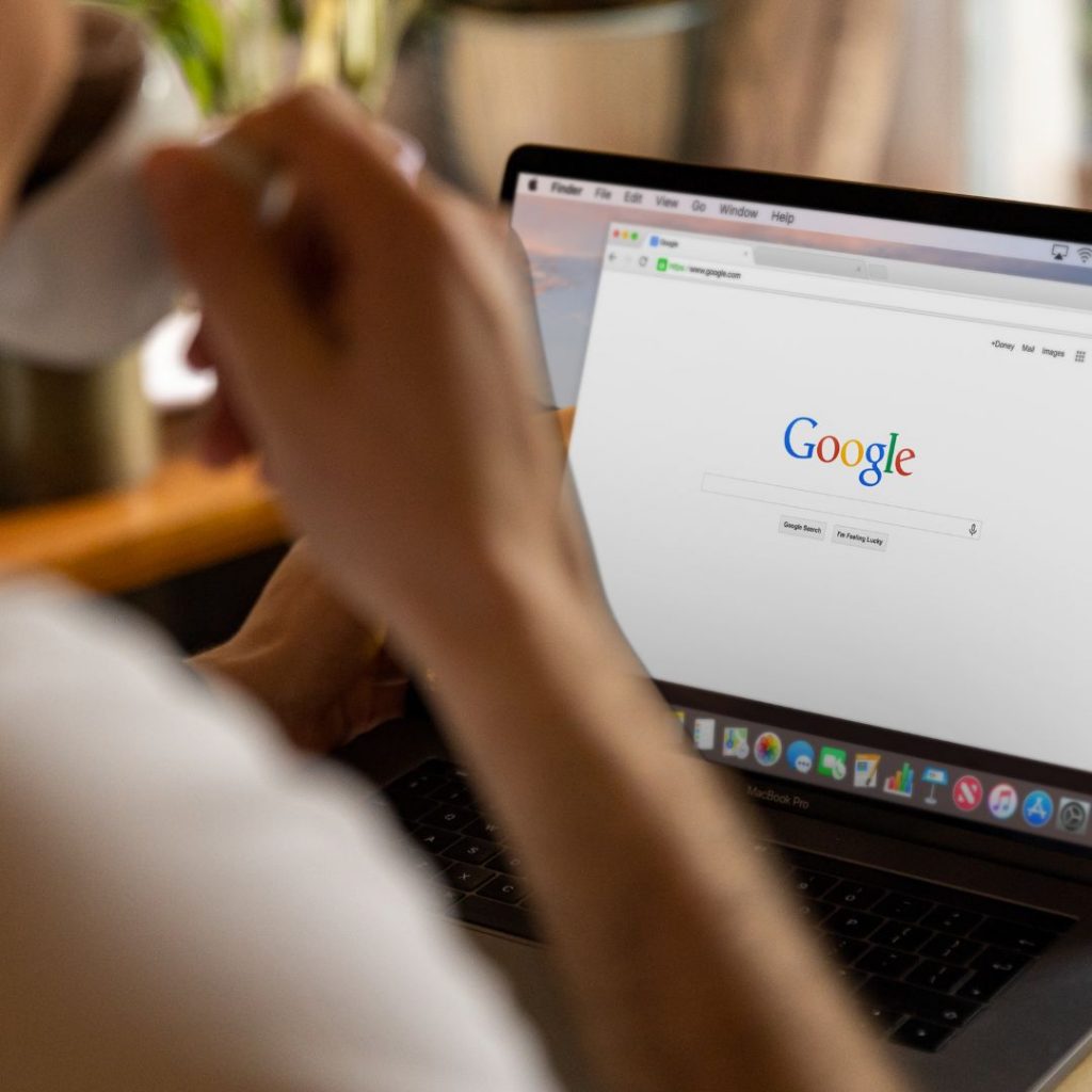 Man looking at Google  search engine on laptop screen