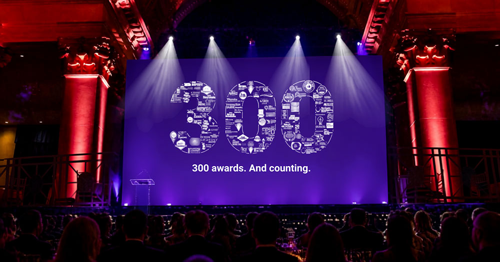 A photo of a stage, displaying Bospar's 300th award announcement